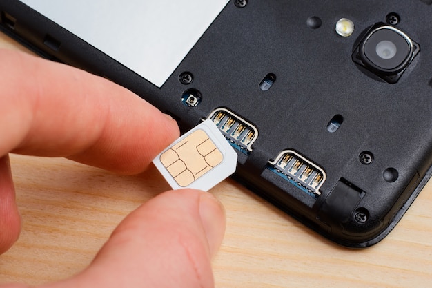 Premium Photo Inserting Sim Card To A Mobile Phone