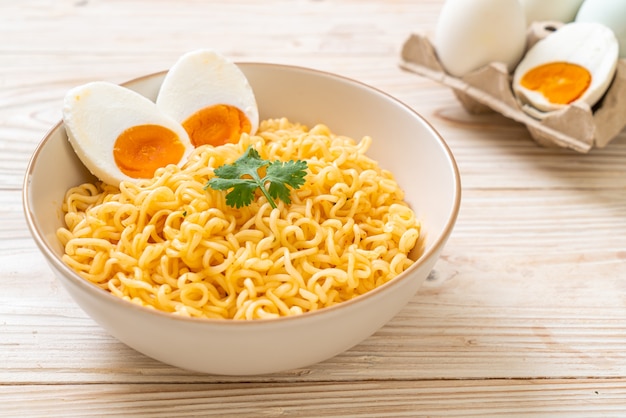 Premium Photo | Instant noodles bowl with salt egg