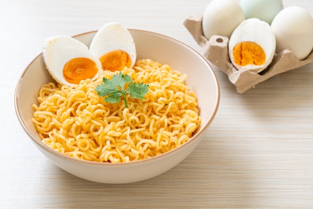 Premium Photo | Instant noodles bowl with salt egg