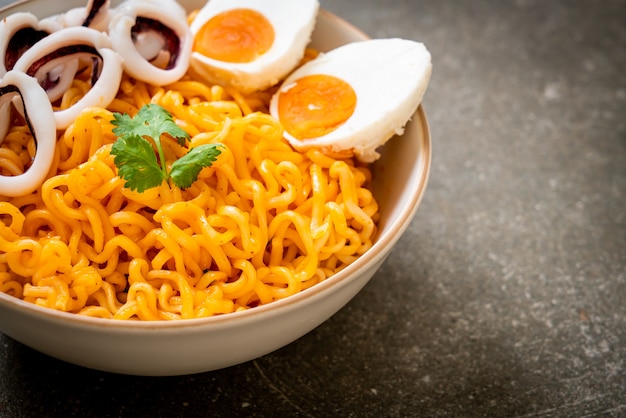 Premium Photo | Instant noodles salt egg flavour with squid or octopus bowl