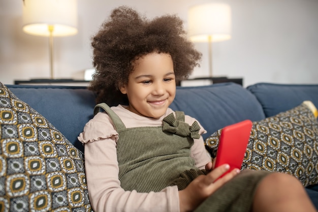 Premium Photo | Interesting here. smiling little dark-skinned girl with ...