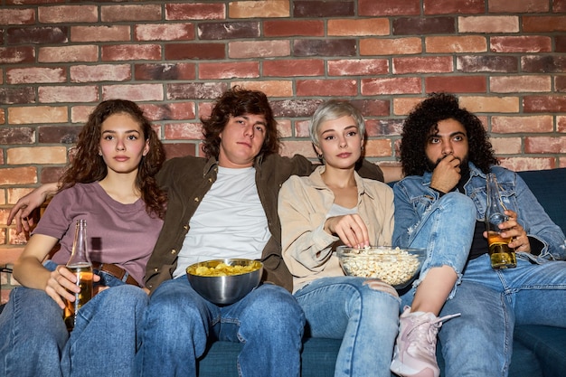 Premium Photo | Interracial friends watch film together at home at ...