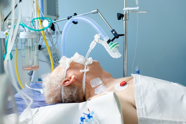 Premium Photo | Intubated adult white man under avl lying in coma in ...