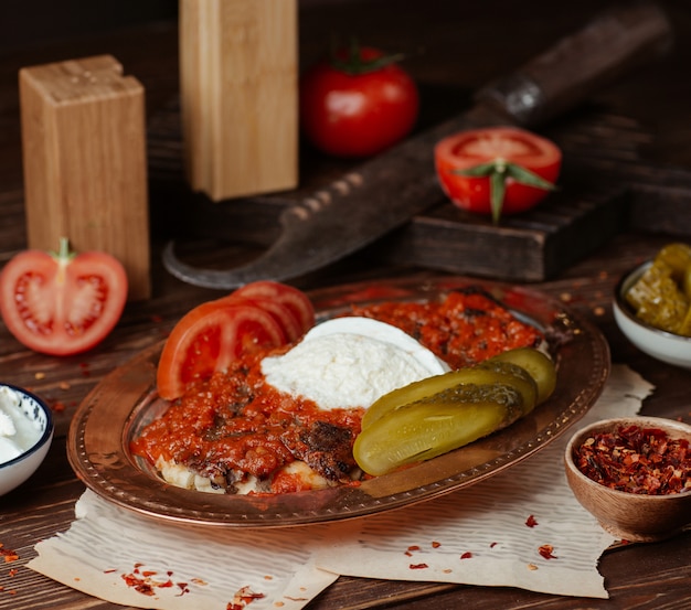 Free Photo Iskender kebab in tomato sauce with yogurt and marinated food