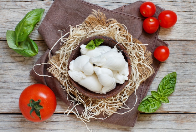 Premium Photo | Italian cheese mozzarella nodini with tomatoes and herbs