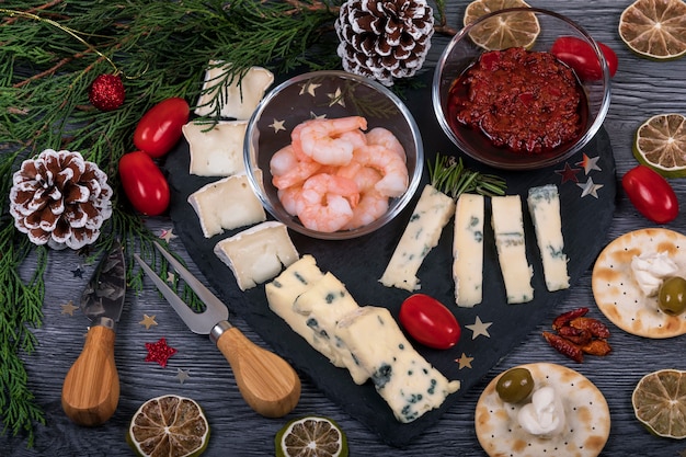 Italian Food On A Dark Cheese Platter With Christmas Decor