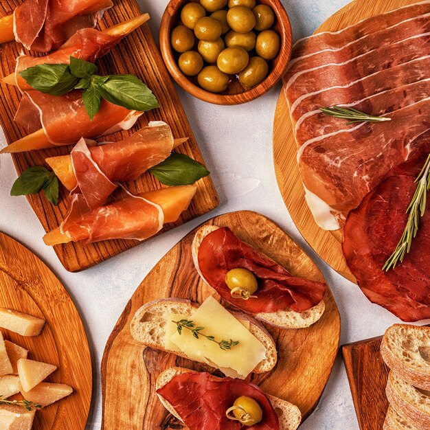 Premium Photo | Italian food table with ham, cheese, olives.