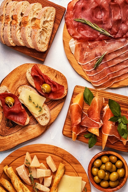 Premium Photo | Italian food table with ham, cheese, olives.