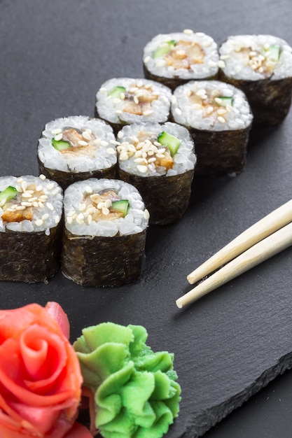 Premium Photo | Japanese restaurant, sushi roll on black slate plate.