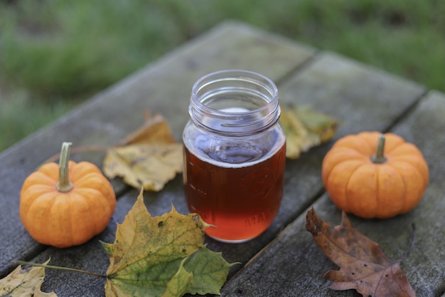 Free Photo | Jar of honey beside two pumpkins