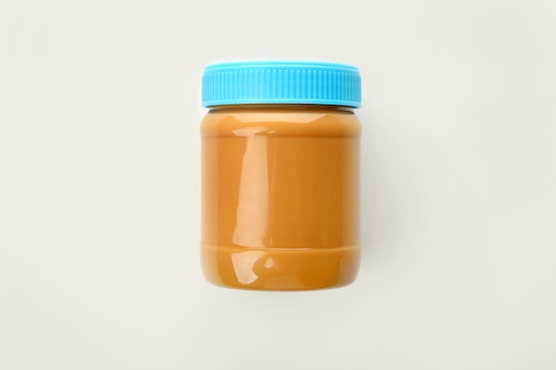 Premium Photo | Jar with tasty peanut butter isolated