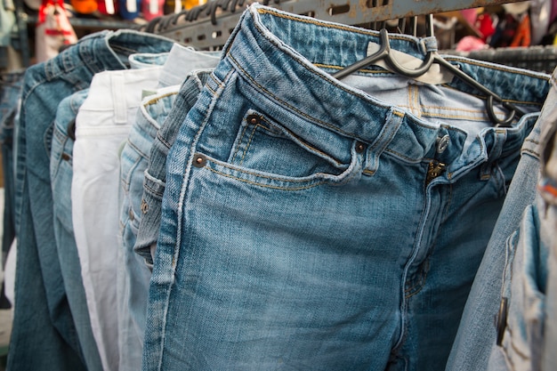 Premium Photo | Jeans on rack