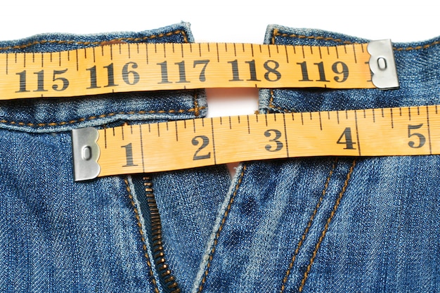 Premium Photo | Jeans and tape measure isolated