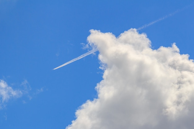 Premium Photo | Jet aircraft with condensation trail on blue sky with ...