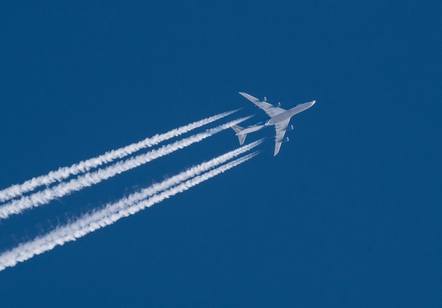 Premium Photo | Jet plane with a white plume on a blue sky