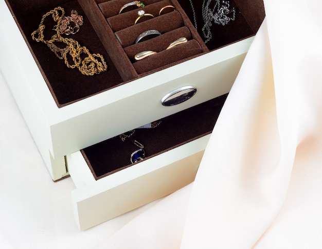 Premium Photo | Jewelry box with jewelry on silk textile background