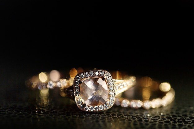 Jewels sparkle in the golden wedding rings lying on the leather  Free Photo
