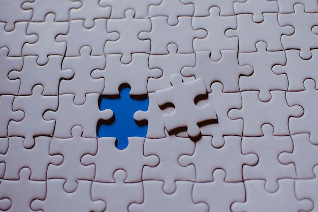 Premium Photo | Jigsaw with one piece missing revealing