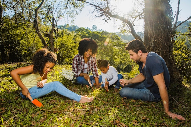 Free Photo | Joyful family sitting under a tree