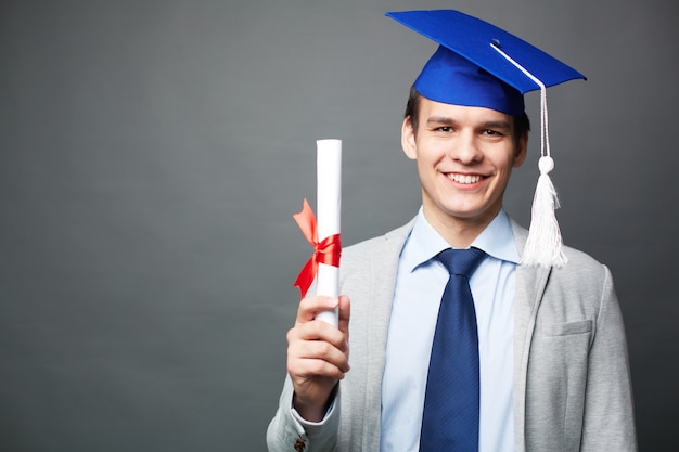 Joyful guy with his diploma Photo | Free Download