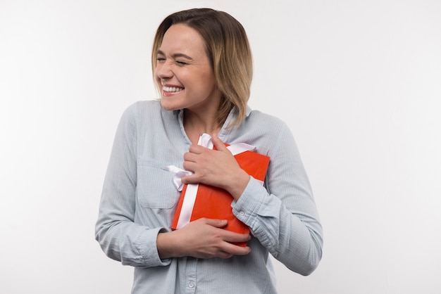 Premium Photo | Joyful mood. delighted nice woman holding the present ...