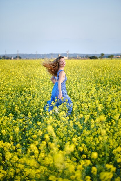 Premium Photo | Joyful woman in sundress walking on blossoming meadow