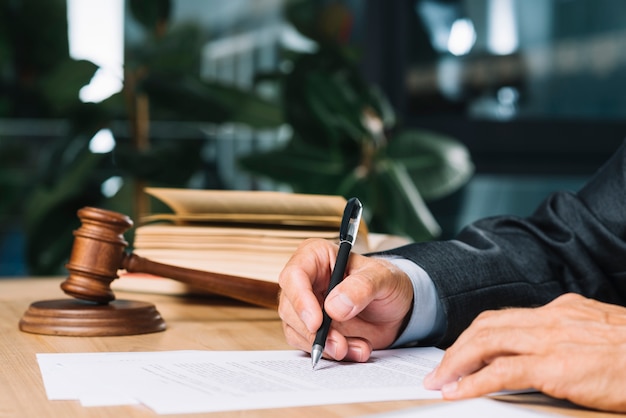 judge-holding-pen-checking-document-wooden-desk_23-2147898393.jpg (626×417)