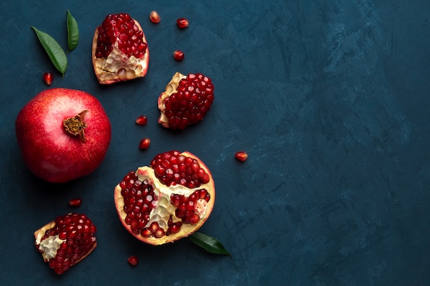  Juicy pomegranate on blue with place for text Premium Photo