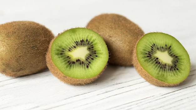 Premium Photo | Juicy ripe kiwi on a wooden table, space for text