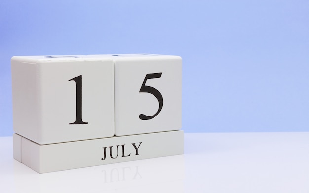 July 15st. day 15 of month, daily calendar on white table with reflection, with light blue background. Premium Photo