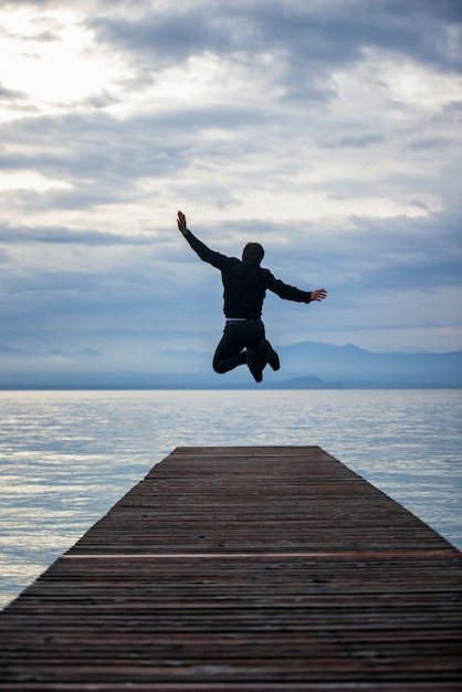 Premium Photo | Jumping on the pier