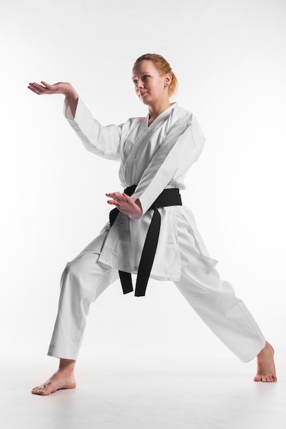 Karate female fighter posing full shot | Free Photo