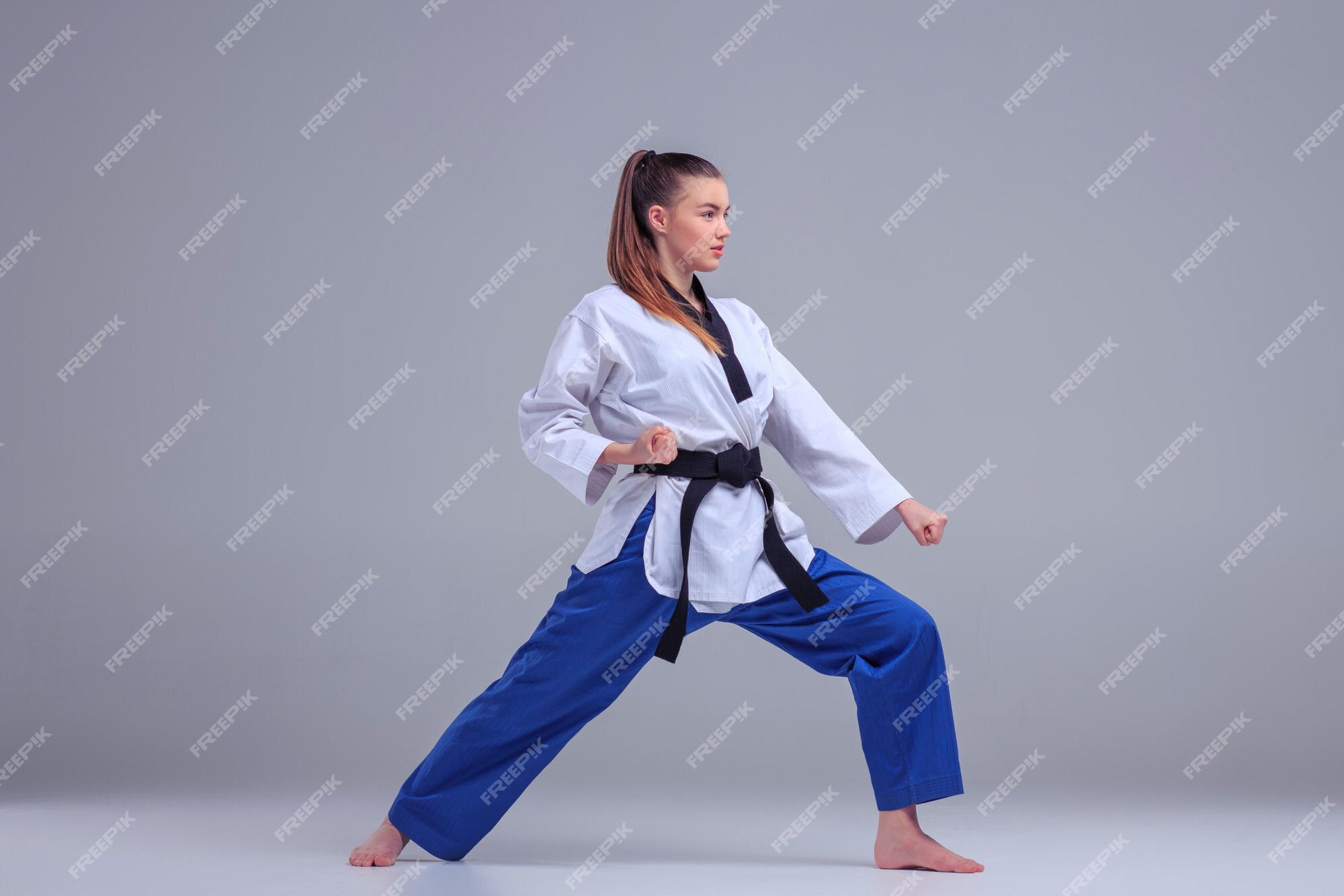 Premium Photo | The karate girl in white kimono and black belt training