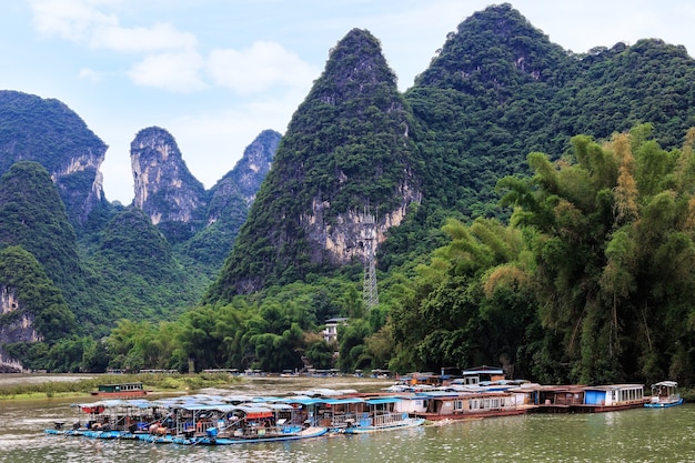 Premium Photo | Karst peaks in xingping town and pleasure boats on the ...