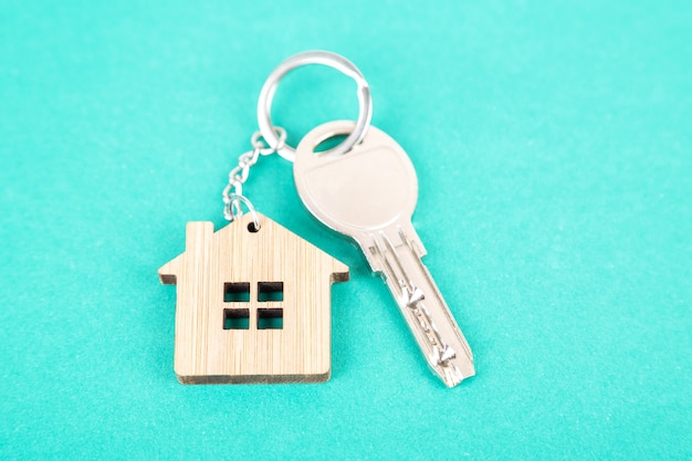 Premium Photo | A key on a house shaped wooden keychain