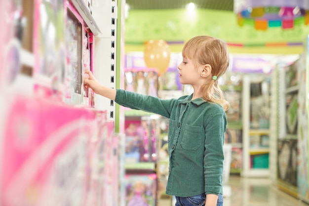 Free Photo | Kid choosing toys for purchase in big store.