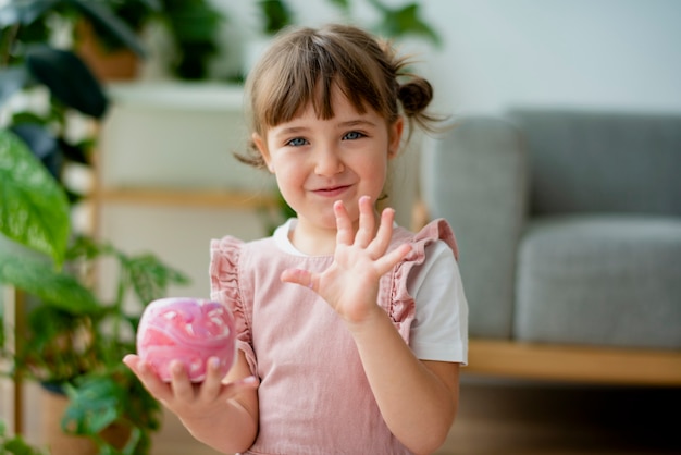 Kid holding a diy painted plant pot Free Photo