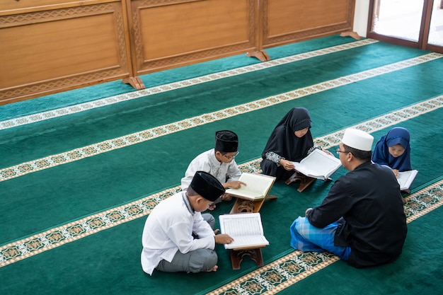 Premium Photo | Kid learning to read quran