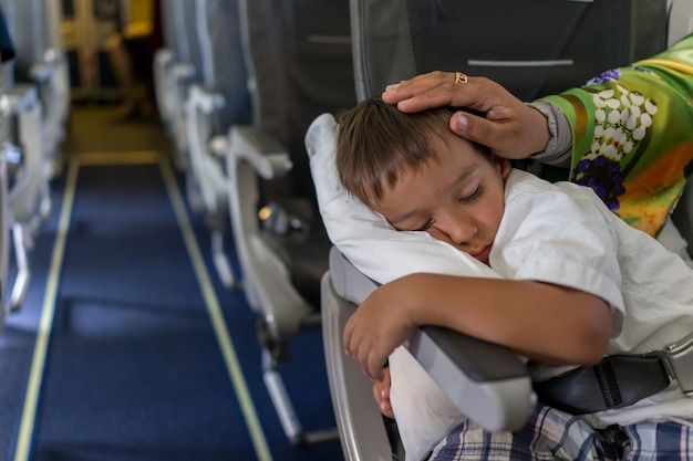 Premium Photo | Kid sleeping inside the airplane during the flight