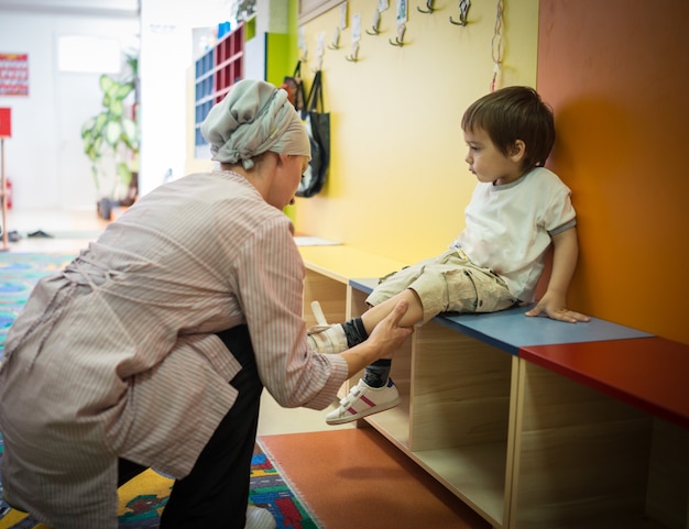 Premium Photo | Kid wearing shoes and sitting