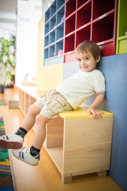 Premium Photo | Kid wearing shoes and sitting