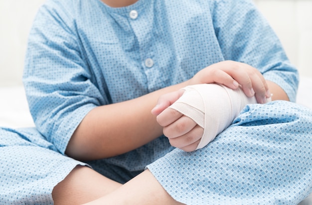 Premium Photo | Kid with broken hand and elastic bandage, kid after ...