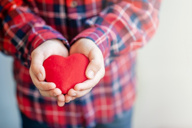 Premium Photo | Kids hands giving red heart and love in valentine's day.