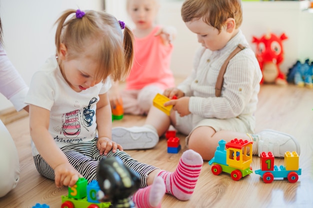 Kids in playroom on floor Free Photo