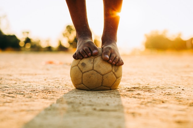 Premium Photo | Kids playing soccer football for exercise with bare foot