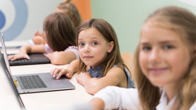 Free Photo | Kids using laptop at school