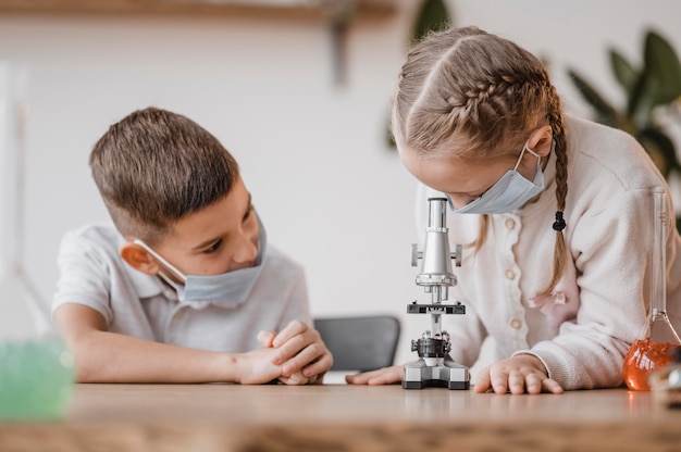 Free Photo | Kids using a microscope to learn science