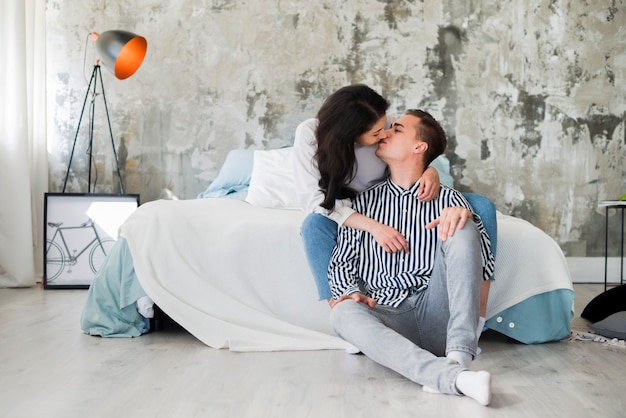 Free Photo Kissing Couple In Industrial Style Bedroom