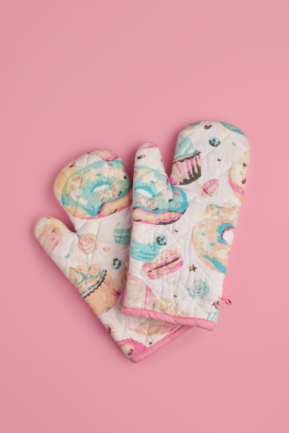 Premium Photo | Kitchen gloves with donuts and cupcakes