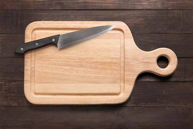 Premium Photo | Knife and cutting board on the wooden background